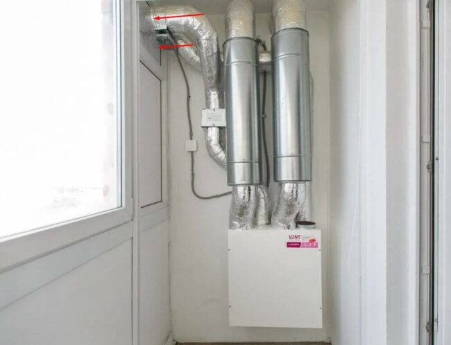 Снимка: Въздуховоди, водещи през остъкляване на балкона към улицата от рекуператор, монтиран на балкона